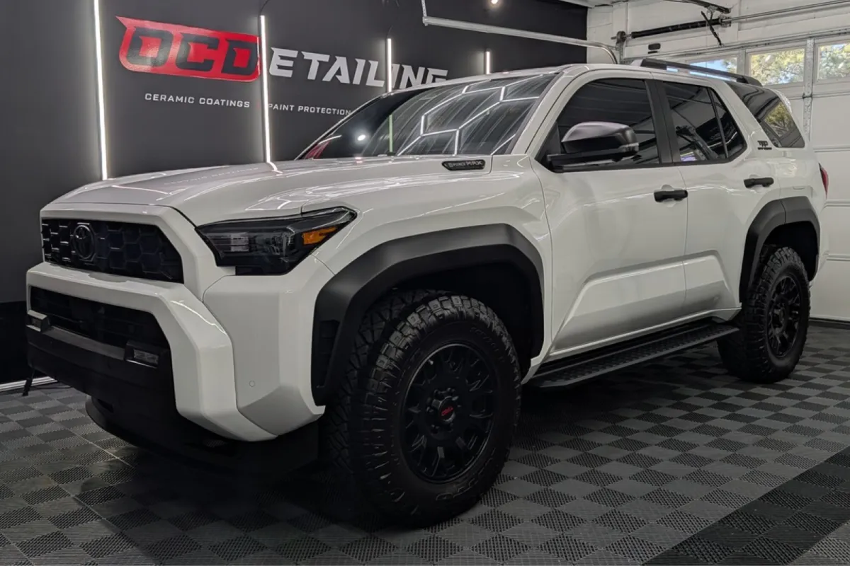 white Toyota inside an auto detailing shop
