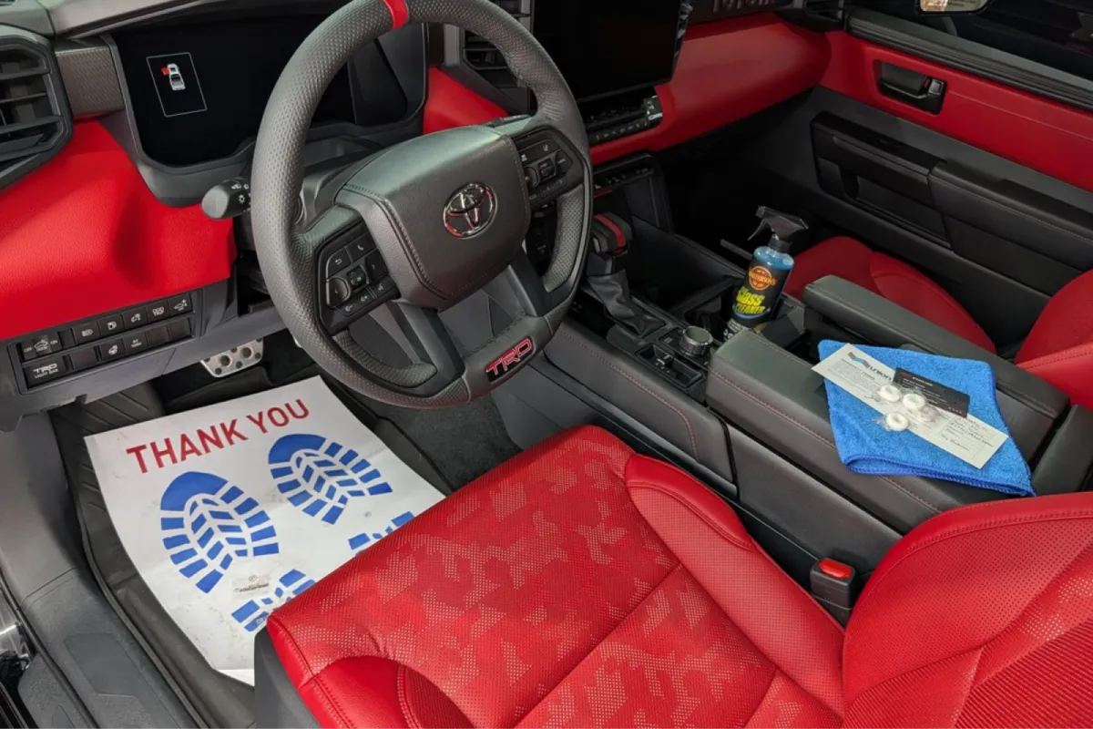 Red leather Toyota TRD interior with clean detailed seats and steering wheel