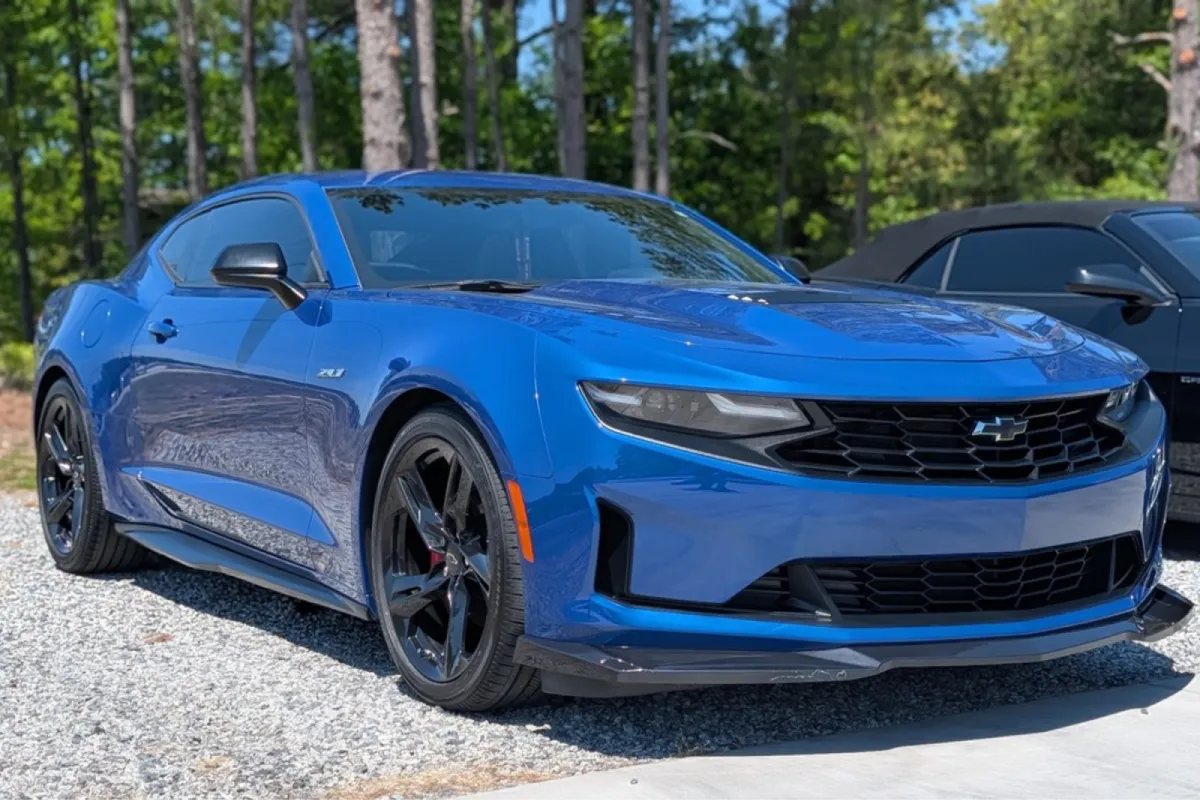 Front view of the blue Chevrolet Camaro ZL1 with aggressive grille