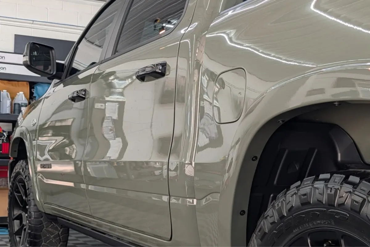 Paint protection film applied on a RAM pickup truck in a workshop, protecting the paint while maintaining a clean, factory-like appearance.