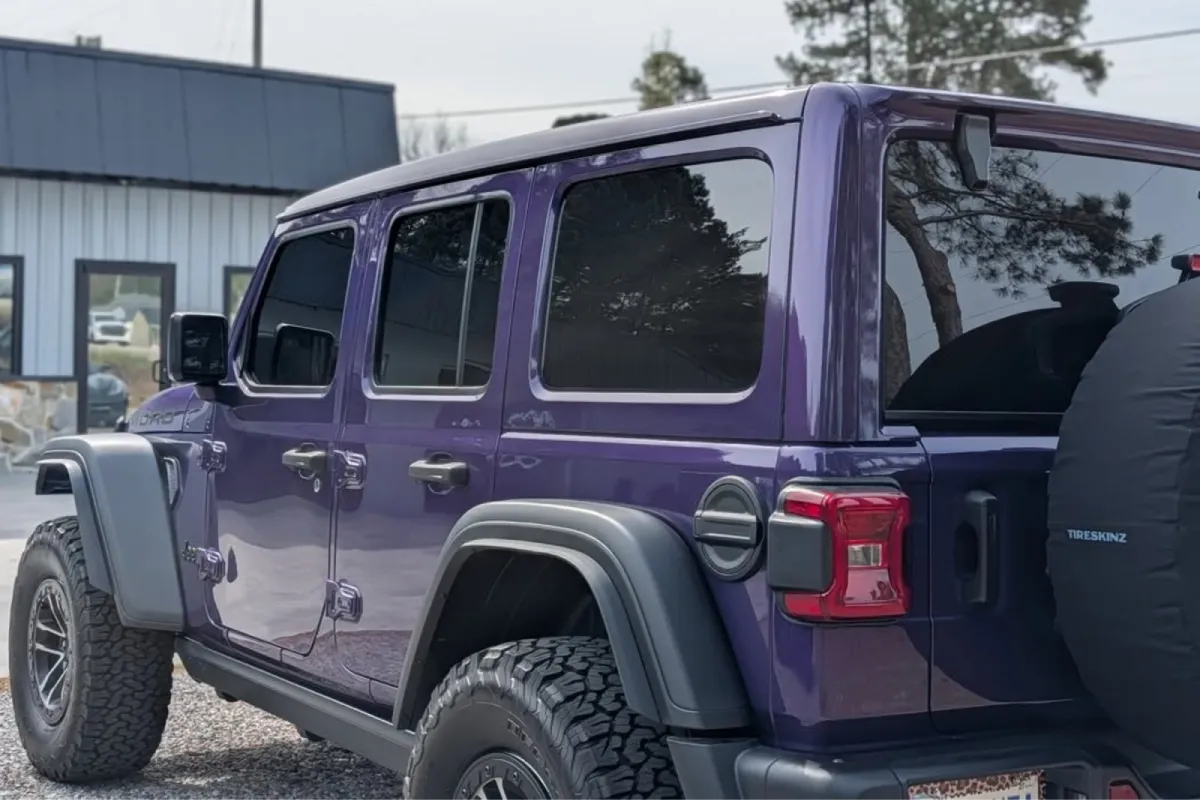 Purple Jeep Wrangler showcasing windshield protection film application with a clean, protected front windshield finish.