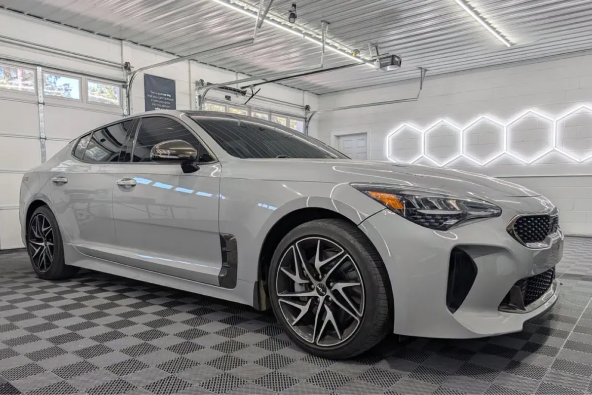 White Kia Stinger with a glossy ceramic coating finish.