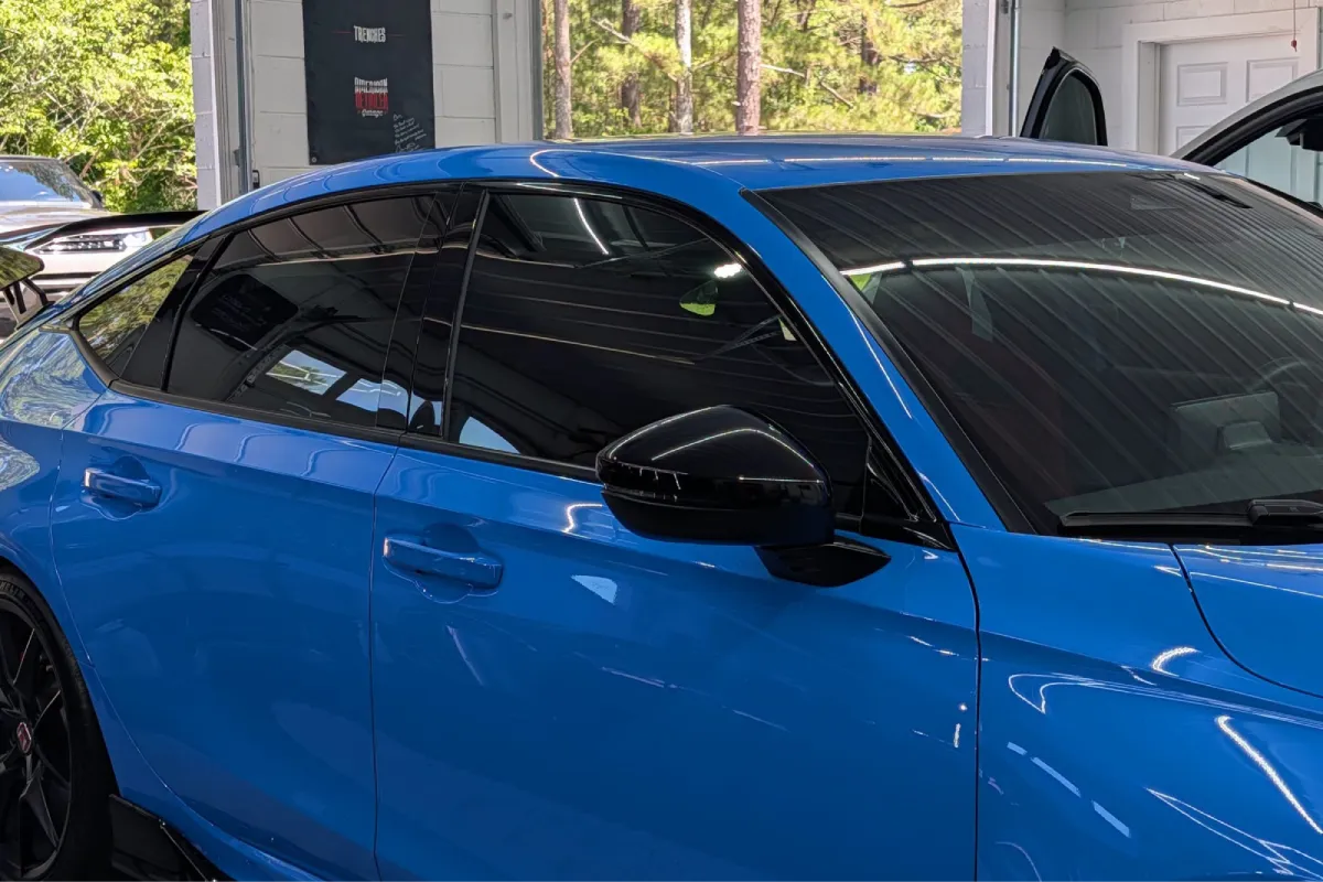 Close-up of a blue Honda Civic with clean tinted windows.